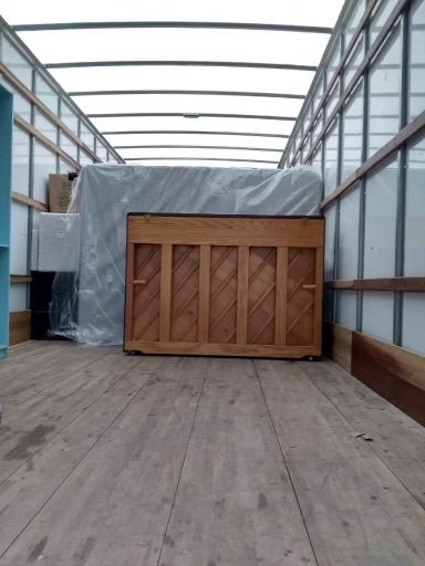 Inside a clean moving truck with padded and wrapped furniture ready for transport